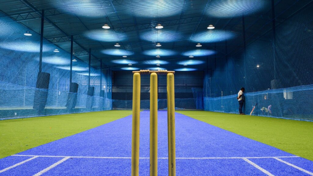 Indoor cricket nets with stumps in the foreground