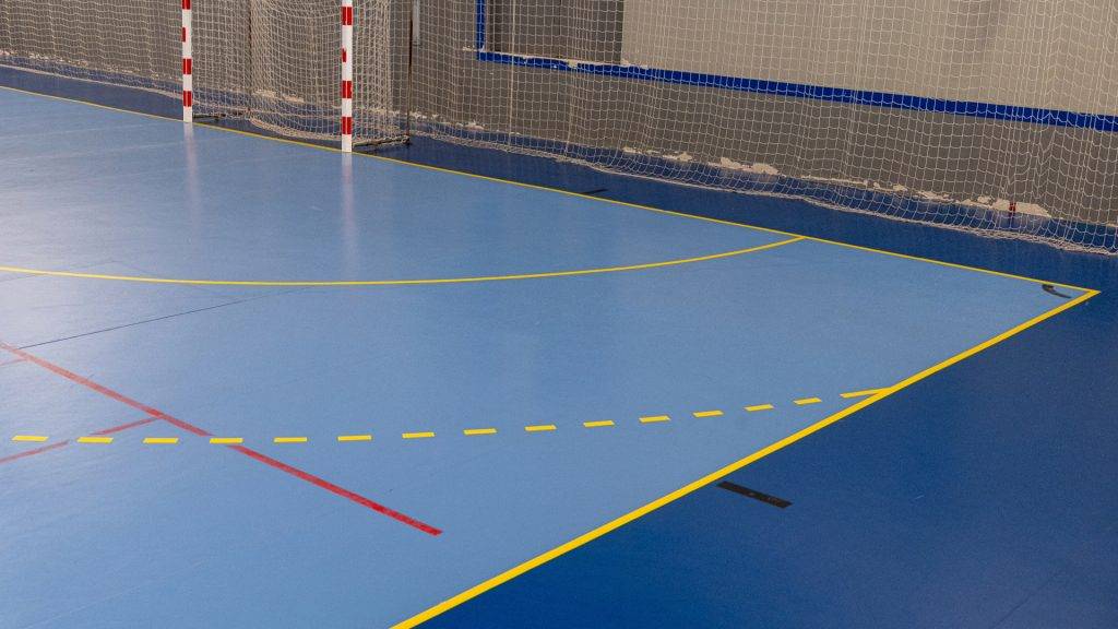 Indoor sports court with handball goal and floor markings