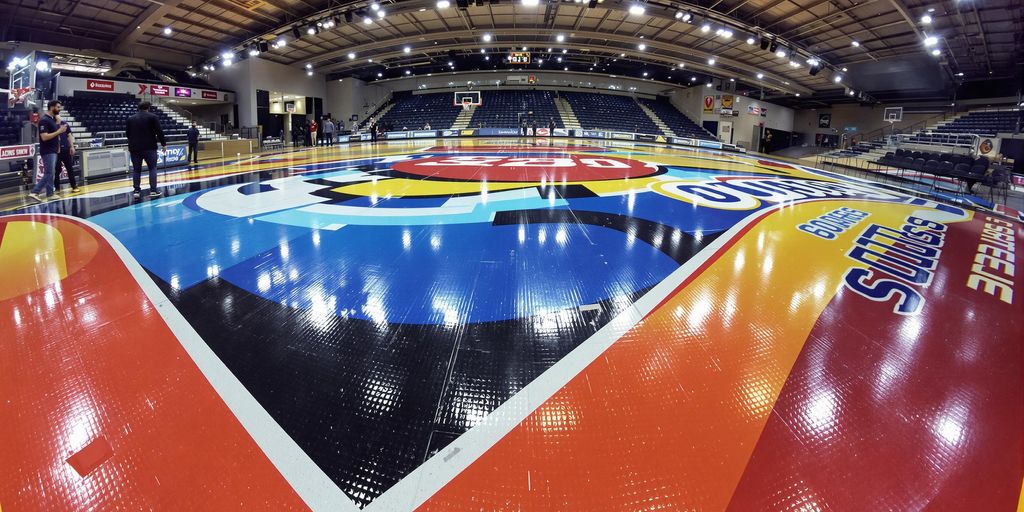 Basketball court with large, colourful floor graphics.