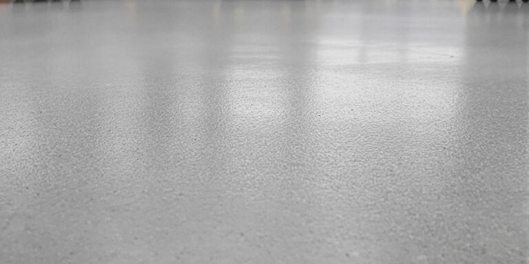 Industrial concrete floor with wheel tracks.