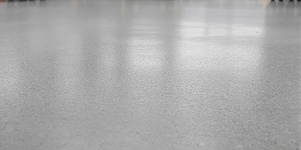 Industrial concrete floor with wheel tracks.