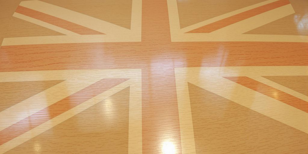 Wooden sports floor with faint Union Jack.