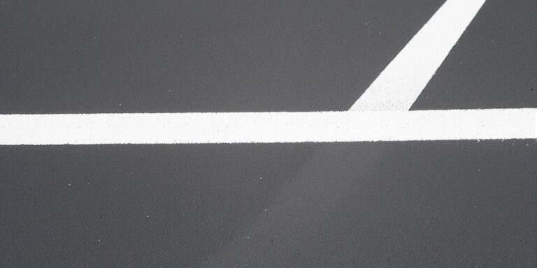 Bright white line on dark sports court.
