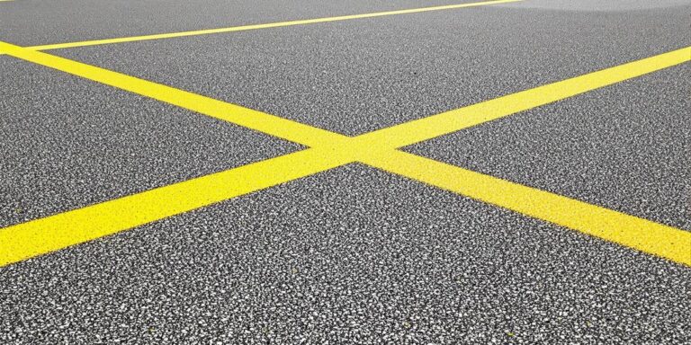 Bright yellow lines on school sports court.