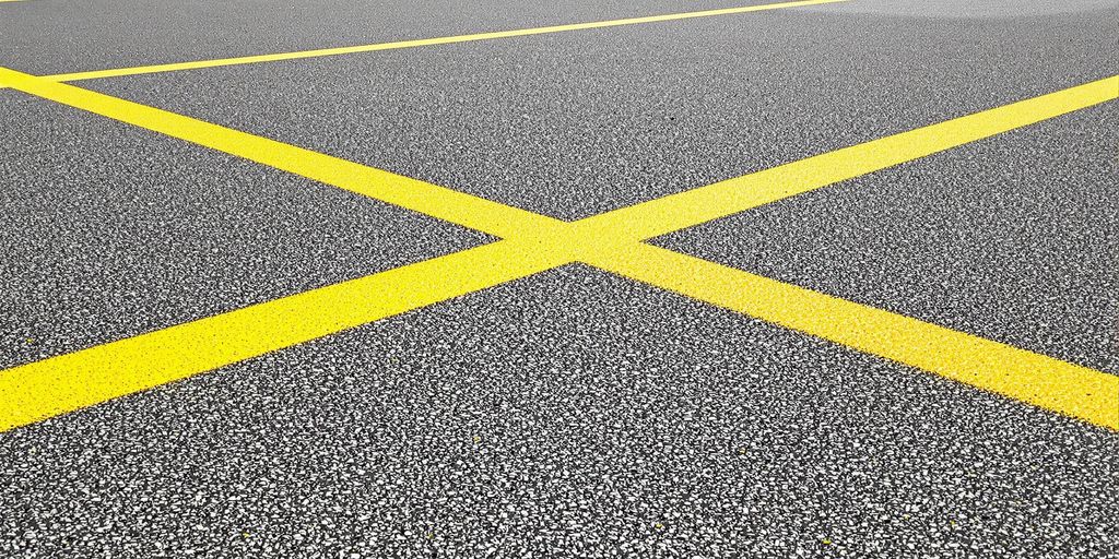 Bright yellow lines on school sports court.