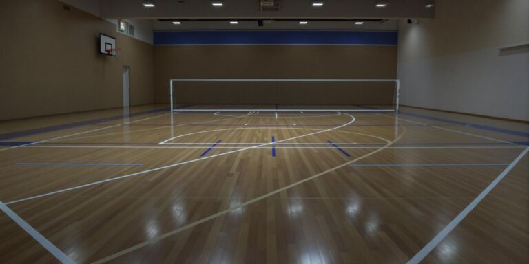 Smooth wooden futsal court, bright lines, Birmingham centre.
