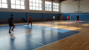 Refurbished sports hall floor with new markings and athletes.